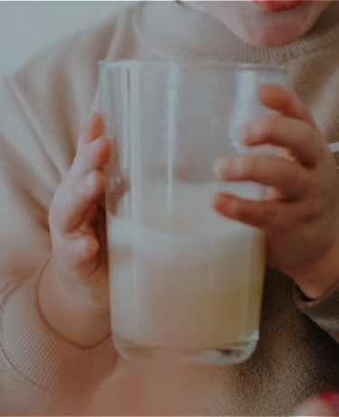 Child drinking a glass of dairy-free formula