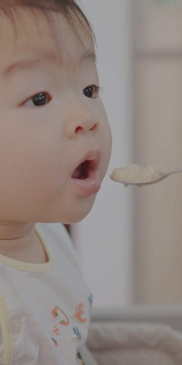 Baby eating friendly allergy food.