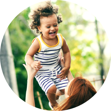 Baby laughing and flying in her mother's arms